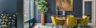 Modern living room with dark walls, colorful furniture, and decorative elements.