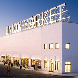 Union Market building with large sign at night